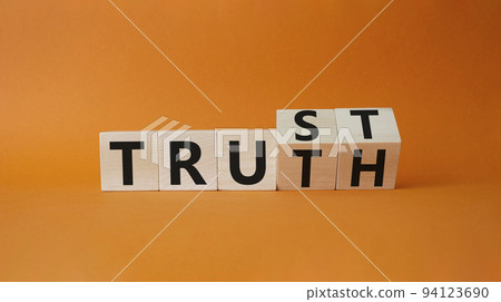 Trust and Truth symbol. Turned cubes with words Truth and Trust. Beautiful orange background. Business and Trust and Truth concept. Copy space 94123690