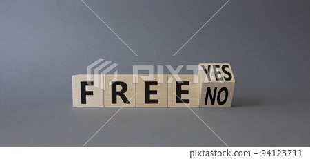 Free symbol. Turned wooden cubes with words Free YES to Free No. Beautiful grey background. Business concept. Copy space Free symbol. Turned wooden cubes with words Free YES to Free No. Beautiful grey background. Business concept. Copy space 94123711