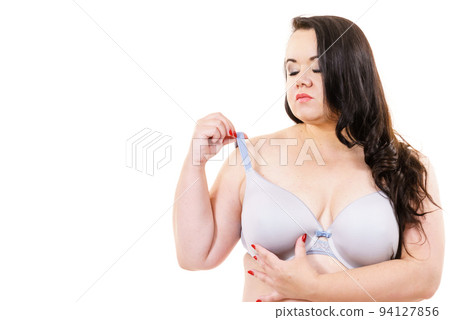 Woman in bra touching her breast. 94127856