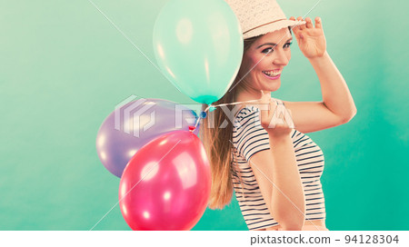 Happy girl playing with colorful balloons. Happy girl playing with colorful balloons. 94128304