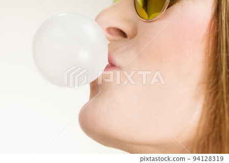 Funky girl blowing balloon. Funky girl blowing balloon. 94128319