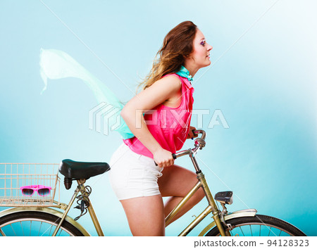 Active woman riding bike bicycle. Hair windblown. Active woman riding bike bicycle. Hair windblown. 94128323