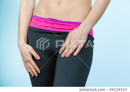 Woman showing some strong abs and flat belly Woman showing some strong abs and flat belly 94128324