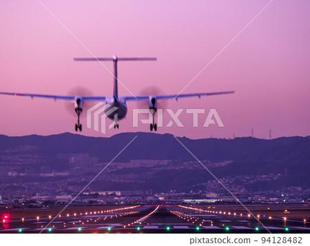 airplane landing at dusk airplane landing at dusk 94128482