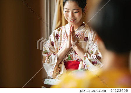 A woman putting her hands together before eating at an inn A woman putting her hands together before eating at an inn 94128496