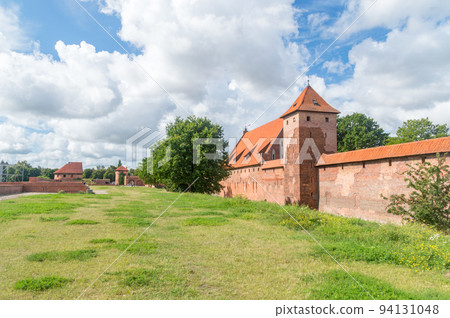 Summer view on Teutonic Knights castle in Malbork. World Heritage list UNESCO. Summer view on Teutonic Knights castle in Malbork. World Heritage list UNESCO. 94131048