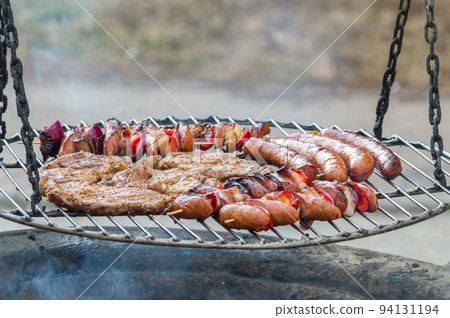 Grilled pork neck, skewers and sausage. Grilled pork neck, skewers and sausage. 94131194