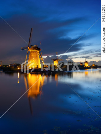Kinderdijk National Park in the Netherlands. Windmills at dusk. A natural landscape 94131293