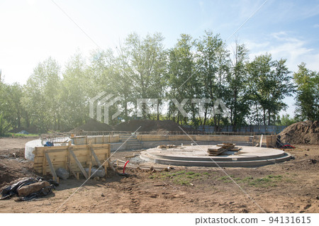 Construction of a round stage stage for performances, pouring the foundation with concrete Construction of a round stage stage for performances, pouring the foundation with concrete 94131615