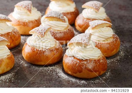 Traditional Swedish easter bun filled with almond paste and whipped cream closeup. Horizontal 94131929