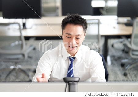 Businessman smiling and having a video call in the office 94132413