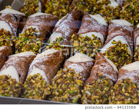 assortment of various Sicilian cannoli with chopped pistachios assortment of various Sicilian cannoli with chopped pistachios 94133569