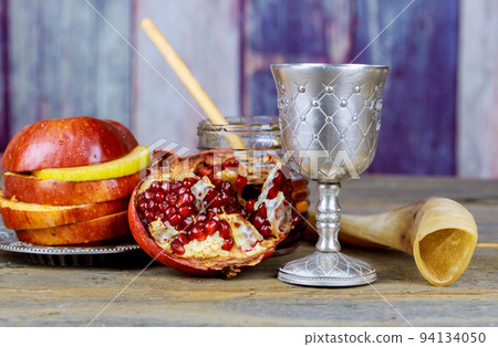 Traditional Jewish New Year symbols include the apple, the honey, the pomegranate and the shofar during the Jewish New Year holiday of Rosh Hashanah Traditional Jewish New Year symbols include the apple, the honey, the pomegranate and the shofar during the Jewish New Year holiday of Rosh Hashanah 94134050