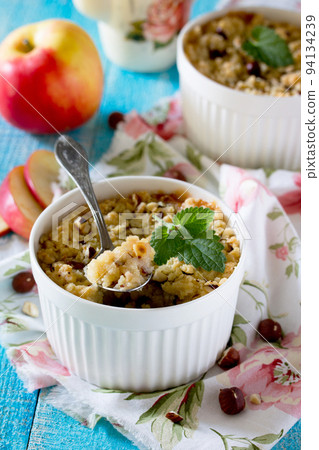 Dessert crumble with apple and nuts in a rustic style 94134239