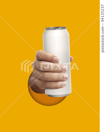 Man holding aluminum can on yellow background Man holding aluminum can on yellow background 94135237