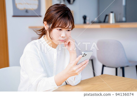 Young woman living room lifestyle smartphone Young woman living room lifestyle smartphone 94136074