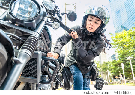 Female rider touring Yokohama on a large cruiser bike Engine trouble Female rider touring Yokohama on a large cruiser bike Engine trouble 94136632
