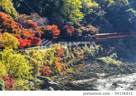 Sagano Scenic Train running through Hozukyo Gorge in late autumn Sagano Scenic Train running through Hozukyo Gorge in late autumn 94136831