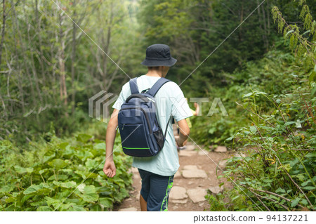 Young Man Traveler with backpack relaxing outdoor hiking traveling in forests. Poland landscape Travel Lifestyle success motivation concept adventure active vacations outdoor. Young Man Traveler with backpack relaxing outdoor hiking traveling in forests. Poland landscape Travel Lifestyle success motivation concept adventure active vacations outdoor. 94137221