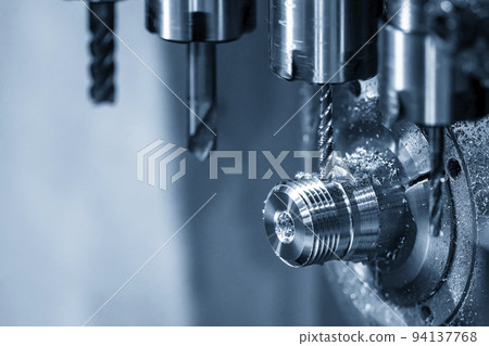 The multi-tasking CNC lathe machine swiss type tapping the brass shaft parts. 94137768