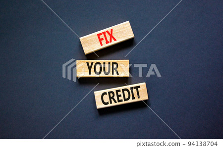 Fix your credit symbol. Concept words Fix your credit on wooden blocks on a beautiful black table black background. Business, finacial and fix your credit concept. Copy space. 94138704