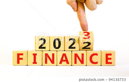 Planning 2023 finance new year symbol. Businessman turns a wooden cube and changes words Finance 2022 to Finance 2023. Beautiful white background, copy space. Business 2023 finance new year concept. 94138733