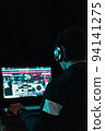 young latin male (Teenager) creating music at home, with headphones and very concentrated looking at the screen. boy producing songs in his bedroom, in a dark room. studying virtual in south america 94141275