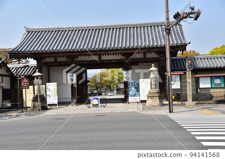 Kyoto City, Kyoto Prefecture, Japan, Toji Temple in spring, with a quaint old gate and the road in front Kyoto City, Kyoto Prefecture, Japan, Toji Temple in spring, with a quaint old gate and the road in front 94141568