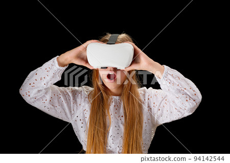 girl, teenager wearing VR glasses and interacting with virtual reality, entertainment technology concept girl, teenager wearing VR glasses and interacting with virtual reality, entertainment technology concept 94142544