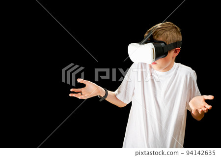 VR Glasses used by a child. Concept of new technology, gaming, education, virtual reality goggles. VR Glasses used by a child. Concept of new technology, gaming, education, virtual reality goggles. 94142635