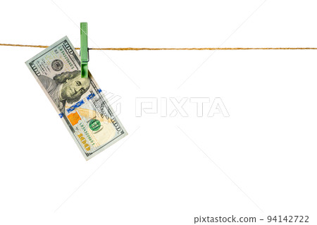 Money laundering. Dollar banknotes hanging on clothesline isolated on white background 94142722