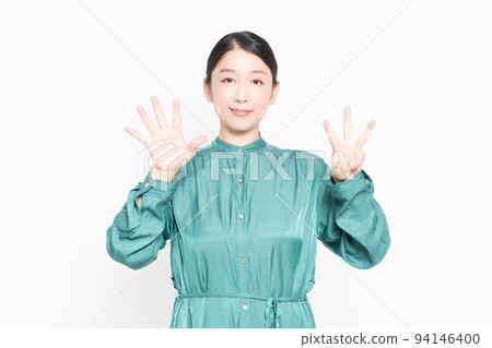 Woman showing the number 8 by hand Woman showing the number 8 by hand 94146400