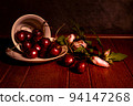 Cherry with hibiscus blossom on a dramatic dark background. still life photography. 94147268