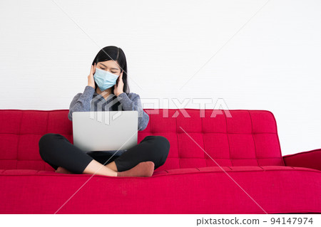 Tired woman wearing a face mask, Headaches and migraines, the suffering of office syndrome after long hours work on the computer. Office syndrome and Health care concept. Tired woman wearing a face mask, Headaches and migraines, the suffering of office syndrome after long hours work on the computer. Office syndrome and Health care concept. 94147974