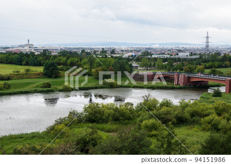The cityscape of Sapporo from the swamp of Moerenuma Park, rich in nature The cityscape of Sapporo from the swamp of Moerenuma Park, rich in nature 94151986