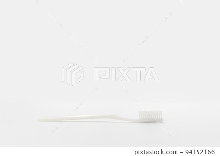 Isolated simple normal white toothbrush is laid on the white background in studio light. Clipping Path. Isolated simple normal white toothbrush is laid on the white background in studio light. Clipping Path. 94152166