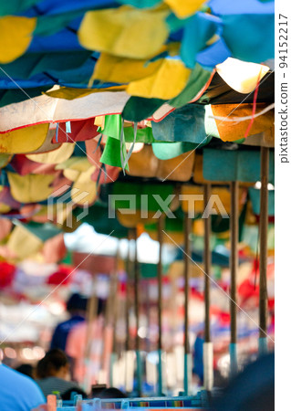 Old and tear Umbrella open to protect the sunshine for Tourists at the Bangsaen Beach Chonburi Thailand. Old and tear Umbrella open to protect the sunshine for Tourists at the Bangsaen Beach Chonburi Thailand. 94152217