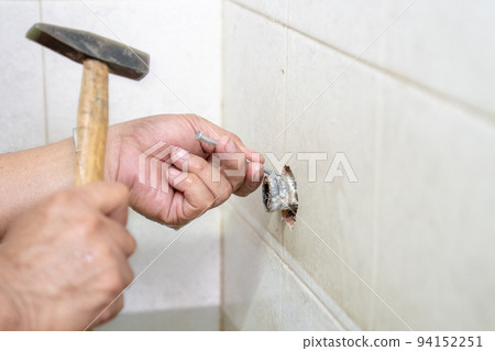Asian man tries to fix and repair pipe / shower in the old restroom. 94152251