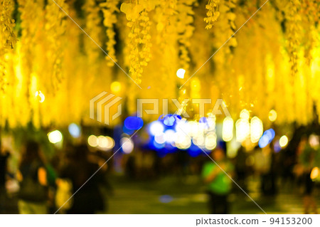 A lot of yellow flower on the ceiling at the night with bokeh behind. 94153200