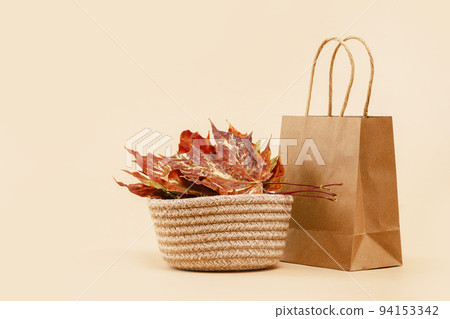 Fall Gift or Sale concept. Shopping paper bag, autumn decor. 94153342