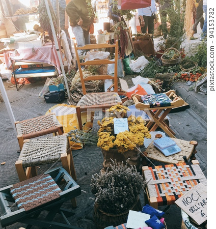 Stylish chairs and dried flowers in a European market Stylish chairs and dried flowers in a European market 94153782