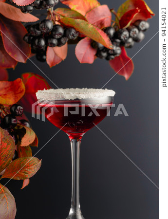 Black chokeberry syrup with berries on a branch. Black chokeberry syrup with berries on a branch. 94154021