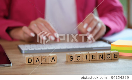 Woman is typing scientific data graphs and statistics on keyboard Woman is typing scientific data graphs and statistics on keyboard 94154259