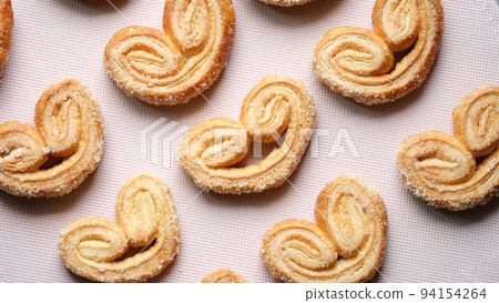 Puff pastry cookies with palms or elephant ears, caramelized and crunchy dough Puff pastry cookies with palms or elephant ears, caramelized and crunchy dough 94154264