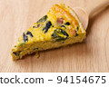 Bacon and spinach quiche on a cutting board 94154675