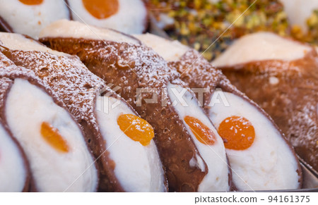 assorted variety of Sicilian cannoli with candied fruit assorted variety of Sicilian cannoli with candied fruit 94161375