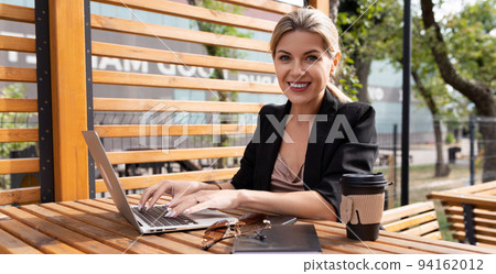 portrait of a young woman working on laptops in the park portrait of a young woman working on laptops in the park 94162012