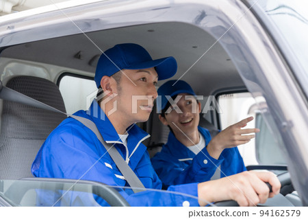 Male staff of a moving company driving a truck 94162579