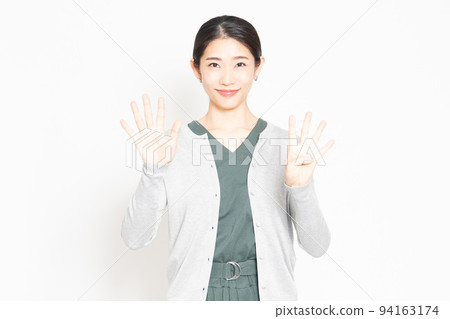 Woman showing the number 9 by hand Woman showing the number 9 by hand 94163174