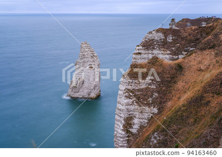 The 'needle rocks' of the Etretat coast rising from the sea at high tide (long exposure) 94163460